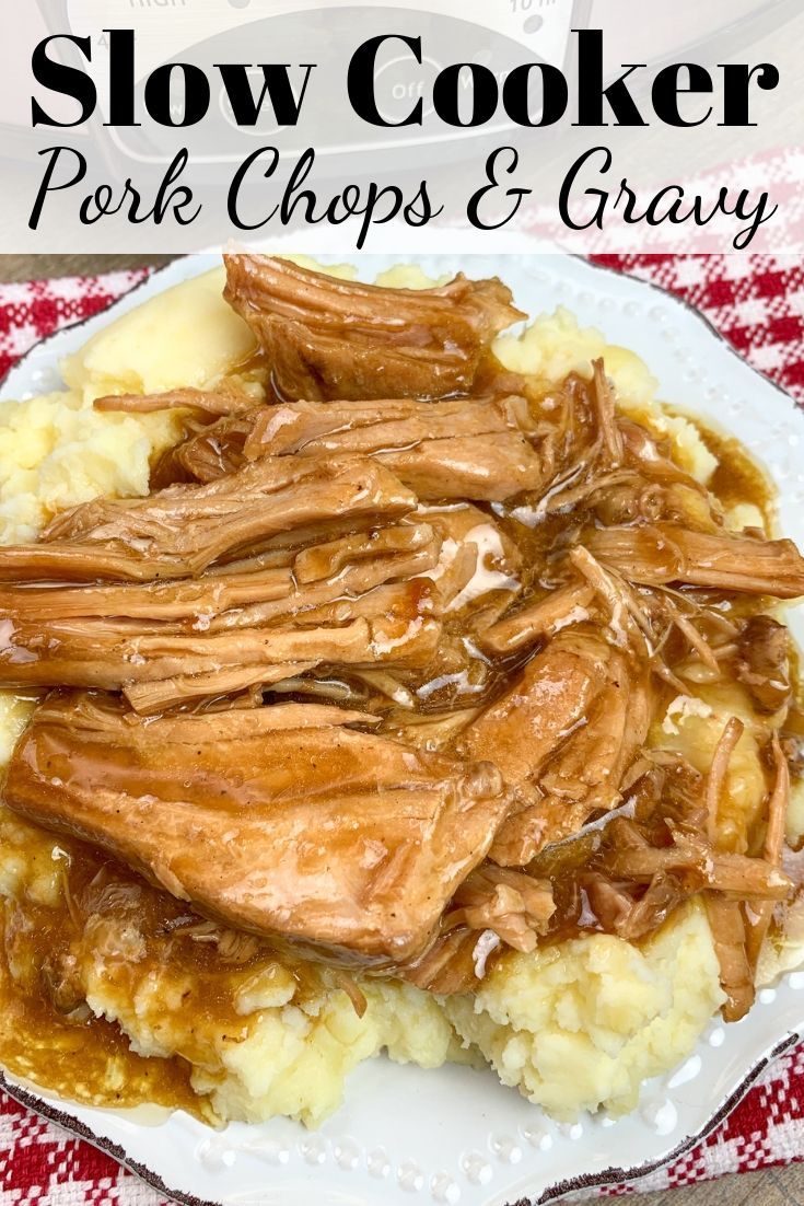 slow cooker pork chops and gravy on top of mashed potatoes