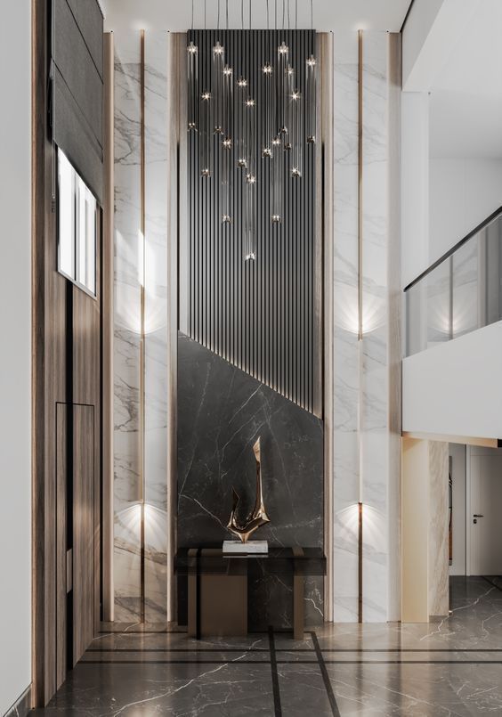 the entrance to an office building with marble floors and walls, chandeliers hanging from the ceiling