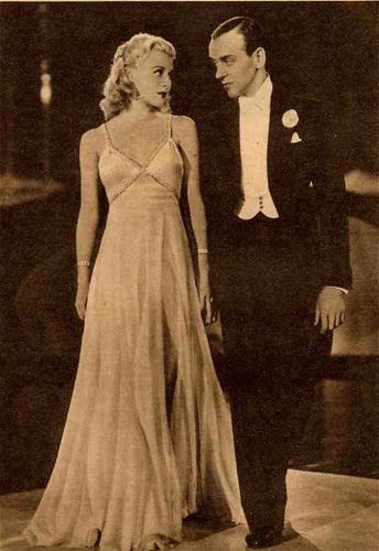 an old photo of a man and woman in formal wear