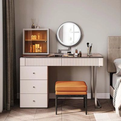 a bedroom with a vanity, stool and mirror