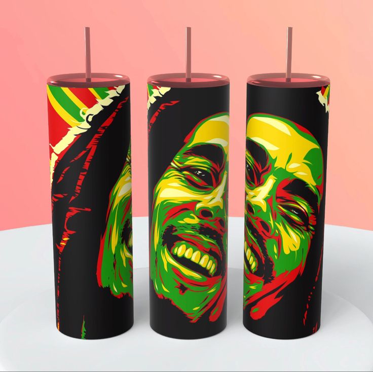 three different colored candles with the faces of two men and one woman painted on them