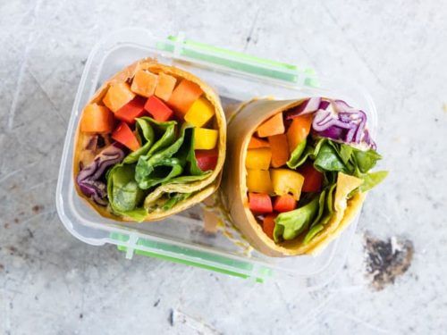 two wraps filled with vegetables on top of a table