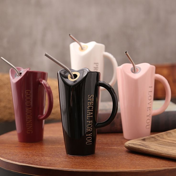 three coffee mugs sitting on top of a wooden table