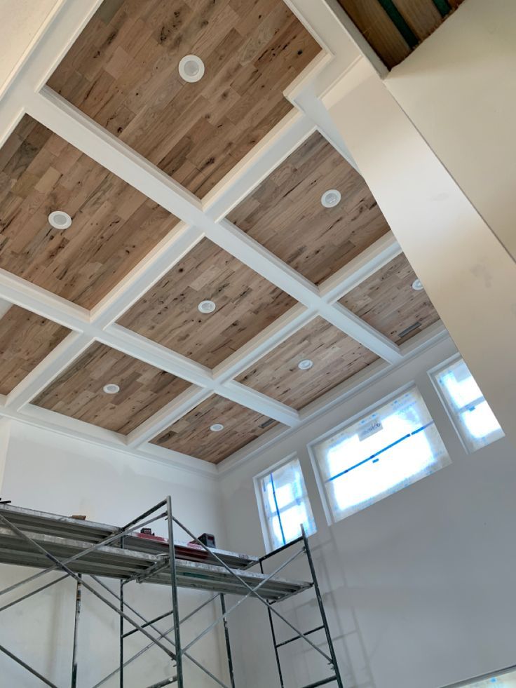 an unfinished ceiling with wooden planks and scaffolding