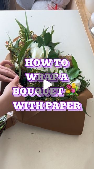 someone is arranging flowers on top of a box with the words how to wrap a bouquet with paper