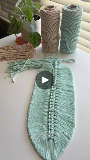 two rolls of twine sitting on top of a table next to some planters