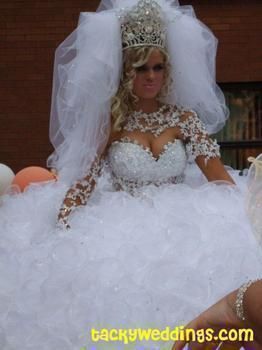 a woman in a wedding dress sitting down