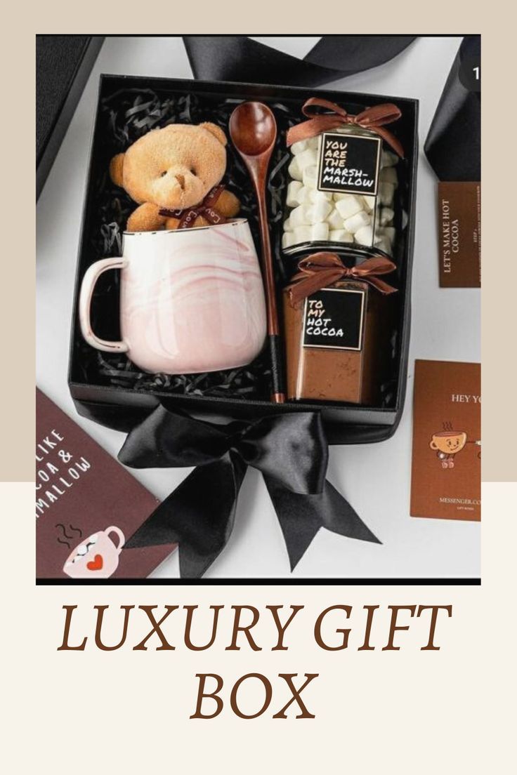 the luxury gift box is filled with chocolates, marshmallows and a teddy bear