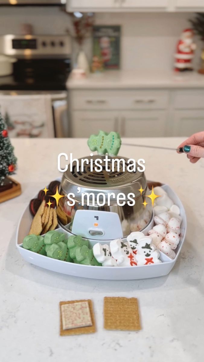 a tray filled with cookies and marshmallows on top of a kitchen counter