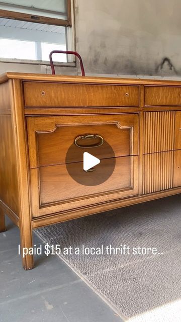 an old wooden dresser with a video playing on it