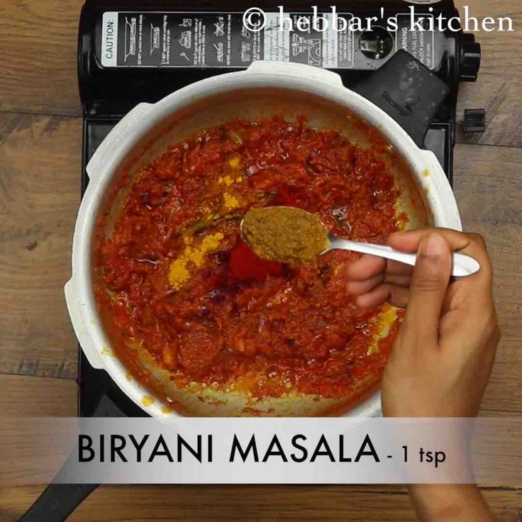 a person spooning food out of a pot on top of a stove with the words, biyani masala 1 tbp