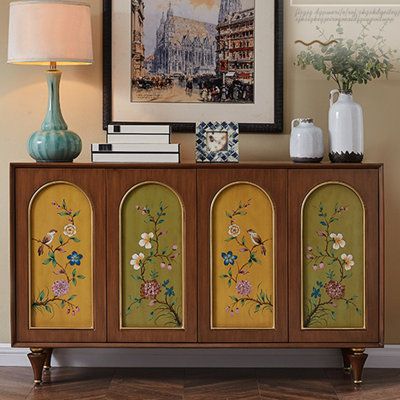 a cabinet with flowers painted on it and two vases sitting on top of it