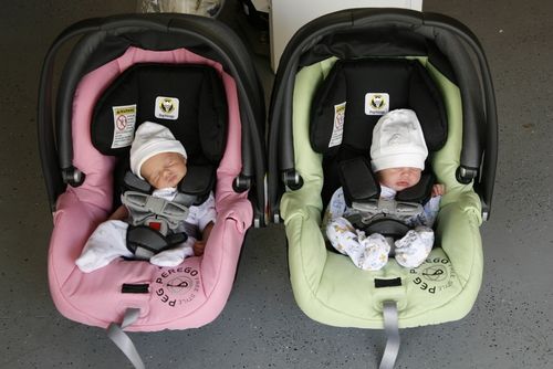 two baby strollers sitting next to each other