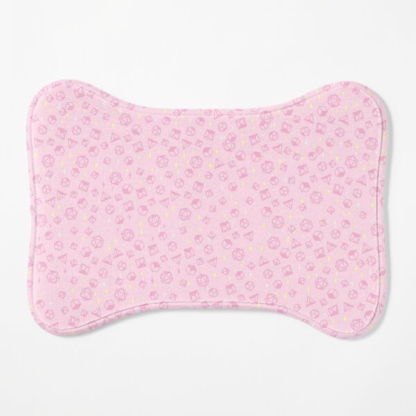 a pink dog bone shaped pillow with flowers and hearts on the front, against a white background