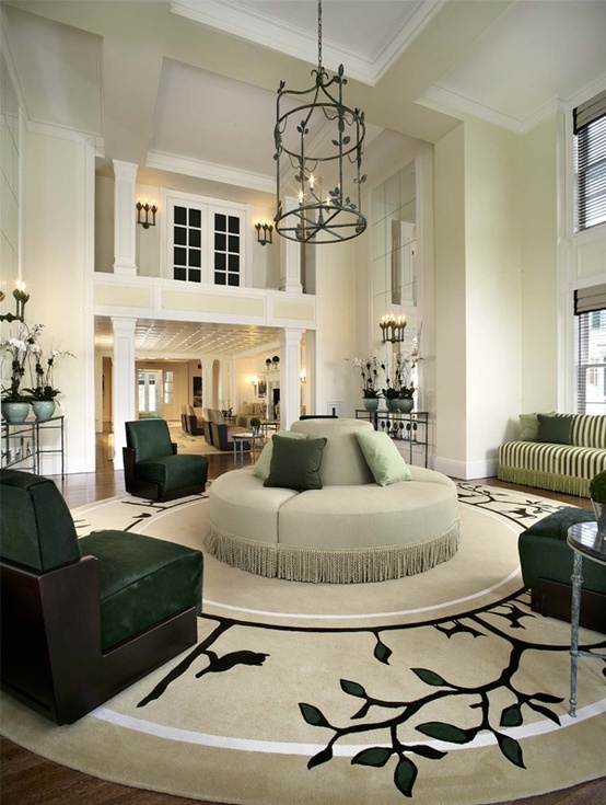 a living room filled with furniture and a chandelier hanging over the top of it