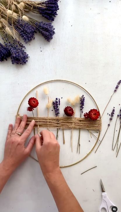 a person is making flowers out of sticks