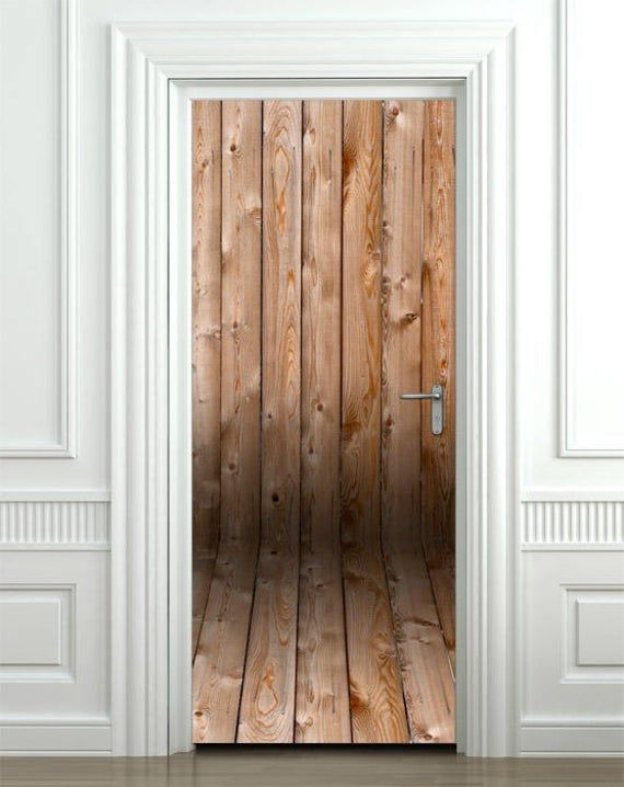 an open wooden door in a white room