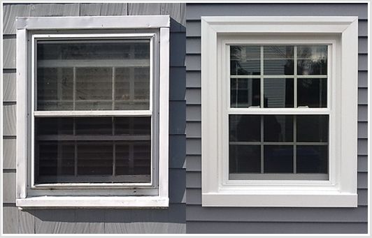 two windows on the side of a gray house