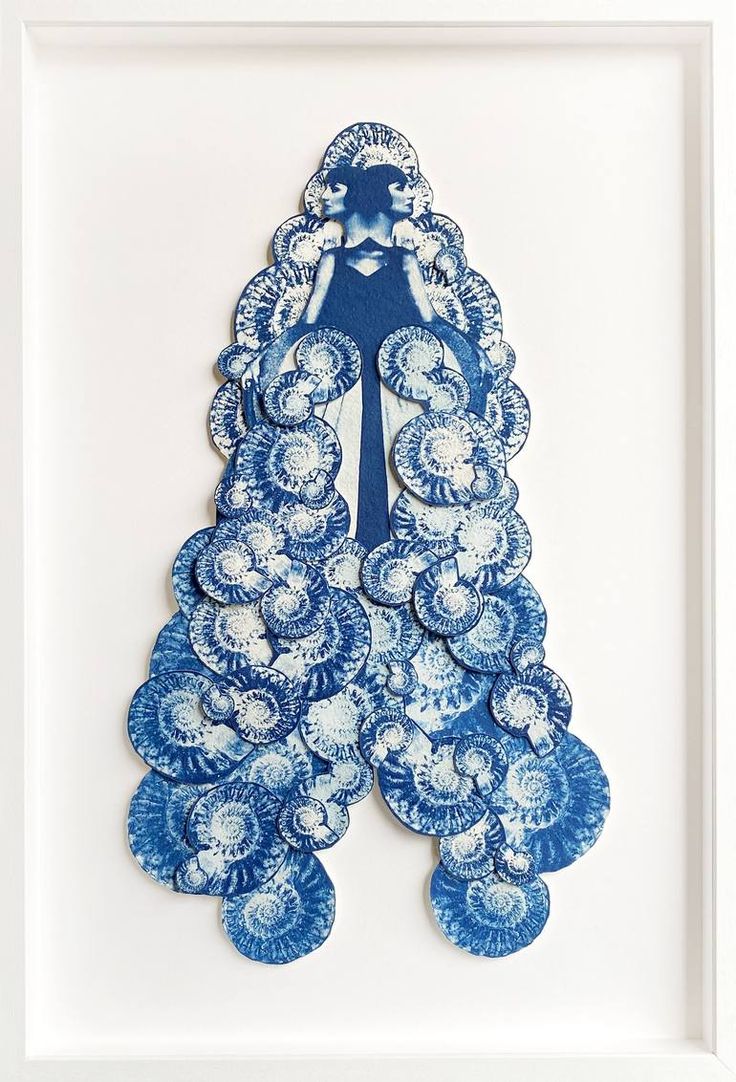 a blue and white peacock print in a frame