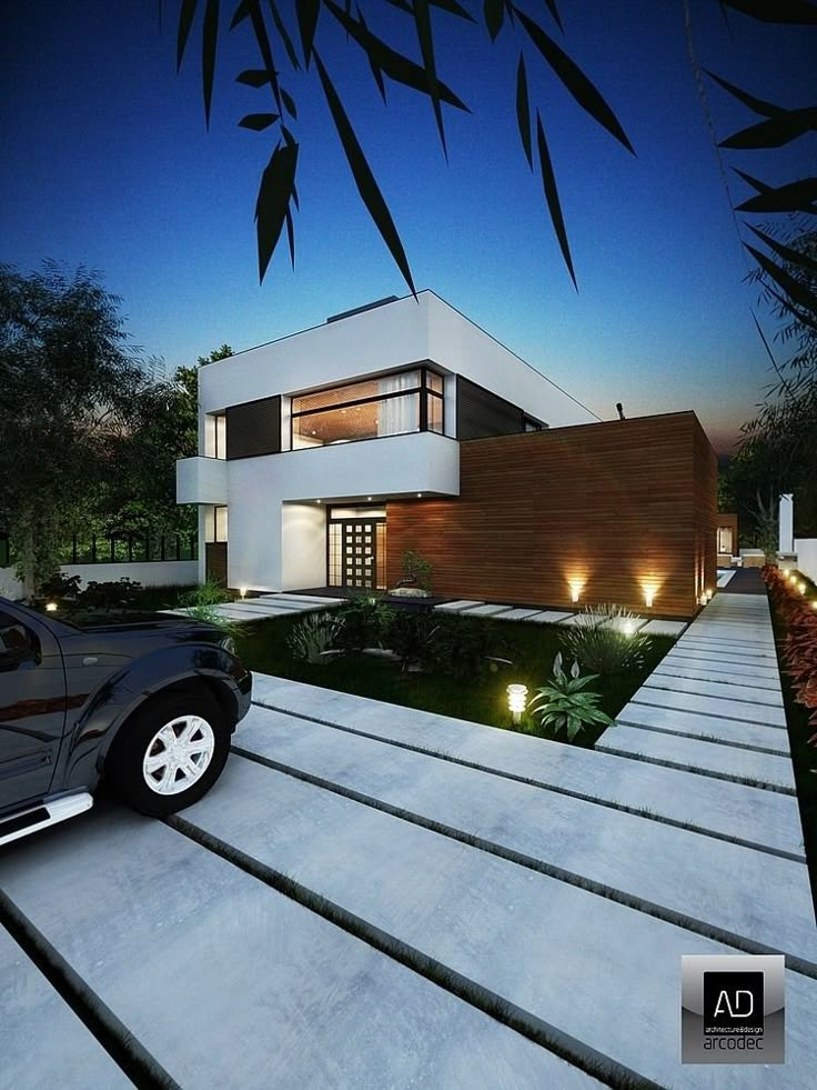 a car is parked in front of a modern house