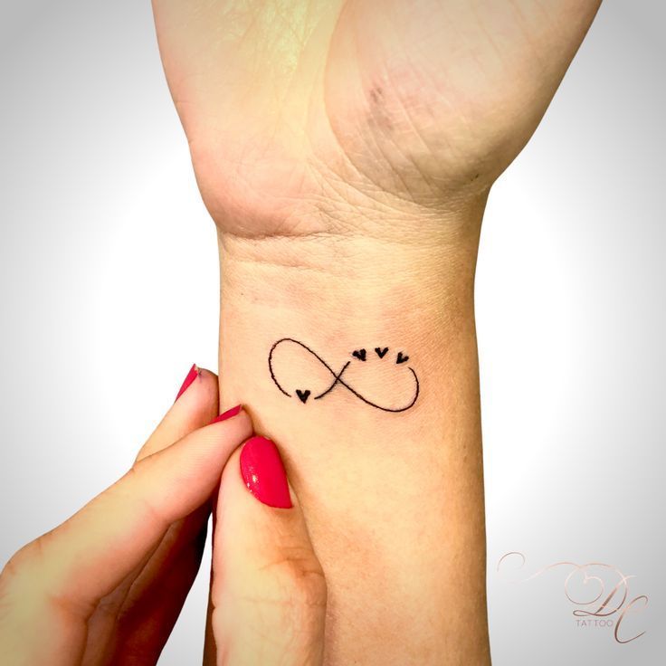 a woman's wrist tattoo with two hearts and an infinite sign on it,