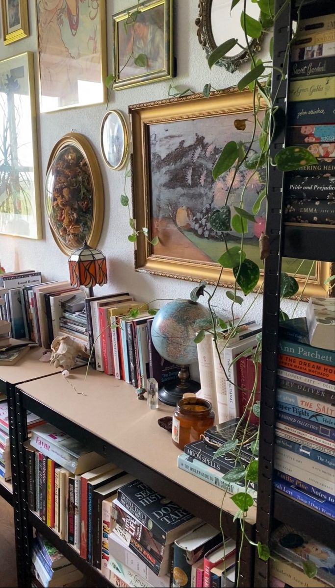 a bookshelf filled with lots of books and plants