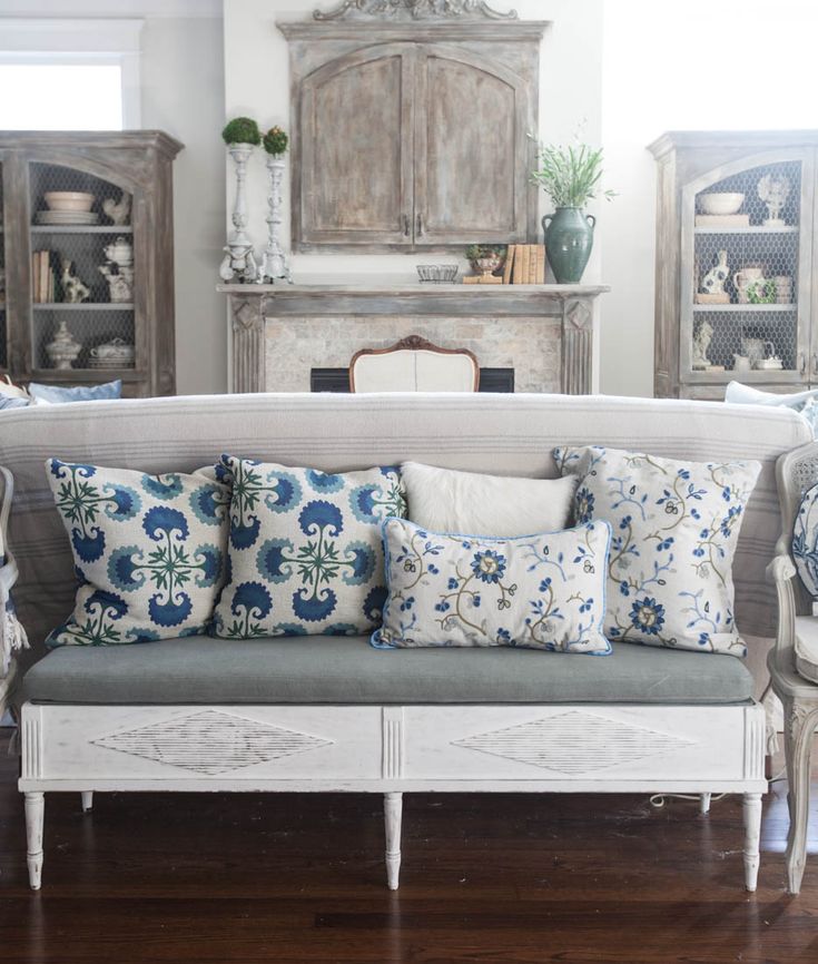 a living room filled with furniture and lots of pillows