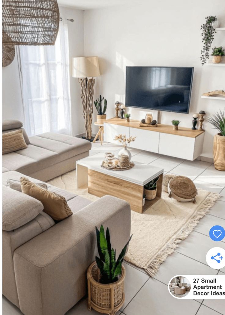 a living room filled with furniture and a flat screen tv sitting on top of a wooden stand