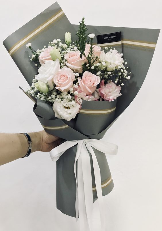 a person holding a bouquet of flowers in their hand