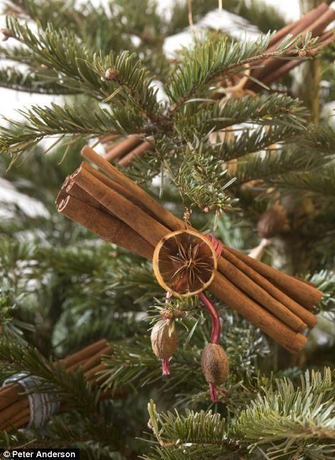 cinnamon stick ornament hanging from a christmas tree