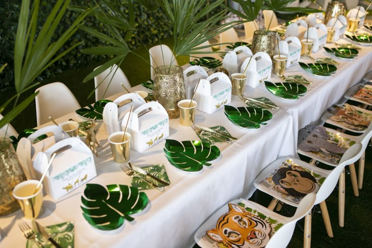 a long table with plates and napkins on it is set up for a party