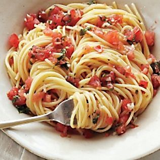 a white bowl filled with pasta and tomatoes