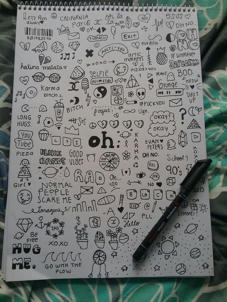 an open notebook with doodles on it and a pen resting on the page next to it