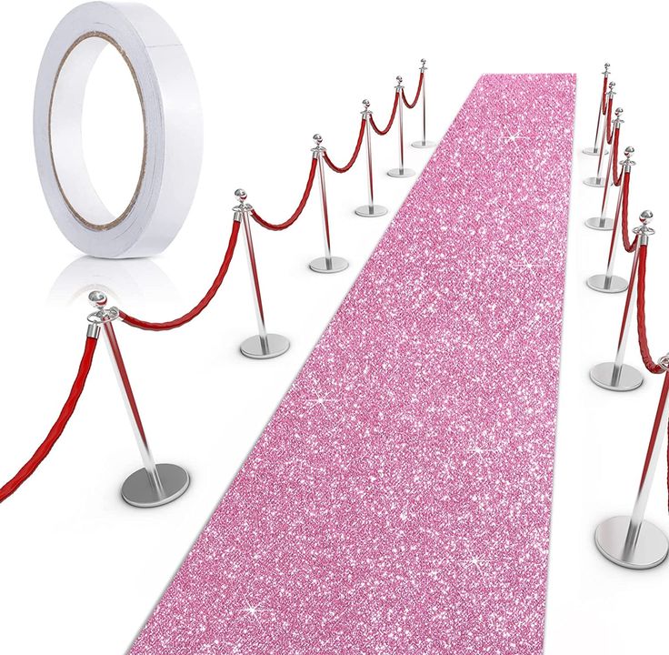 a pink carpet with red rope and silver poles