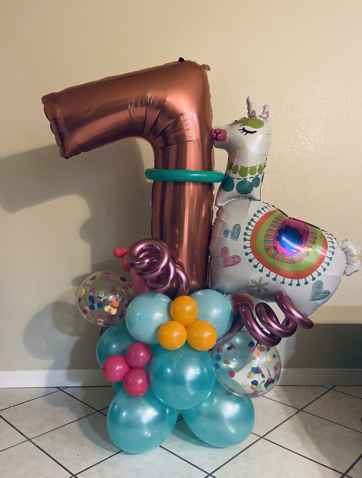 the number one balloon bouquet is filled with helium balloons and other items for an animal themed birthday party