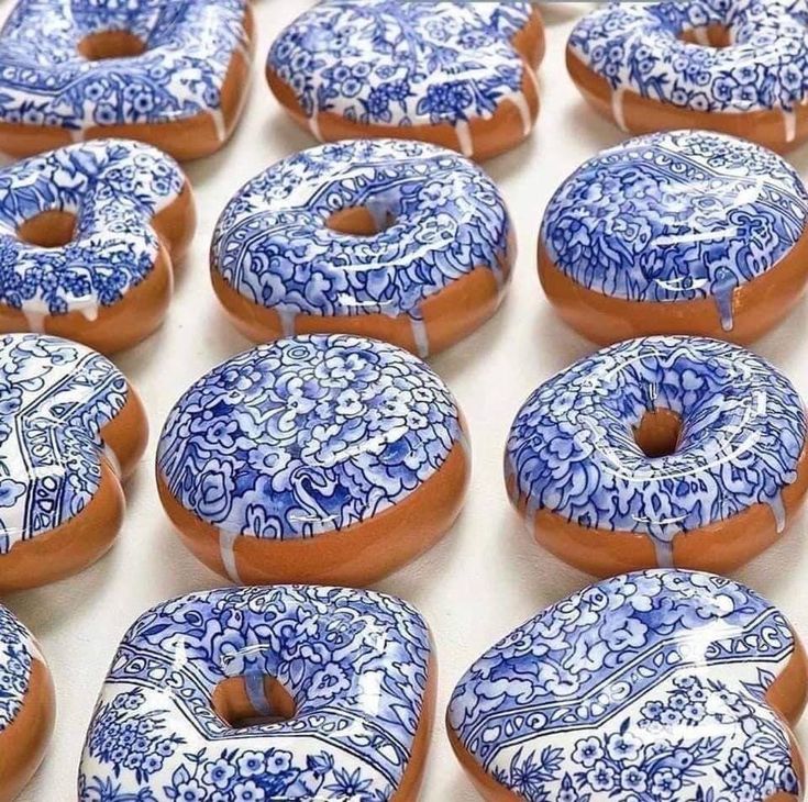 glazed donuts with blue and white designs on them