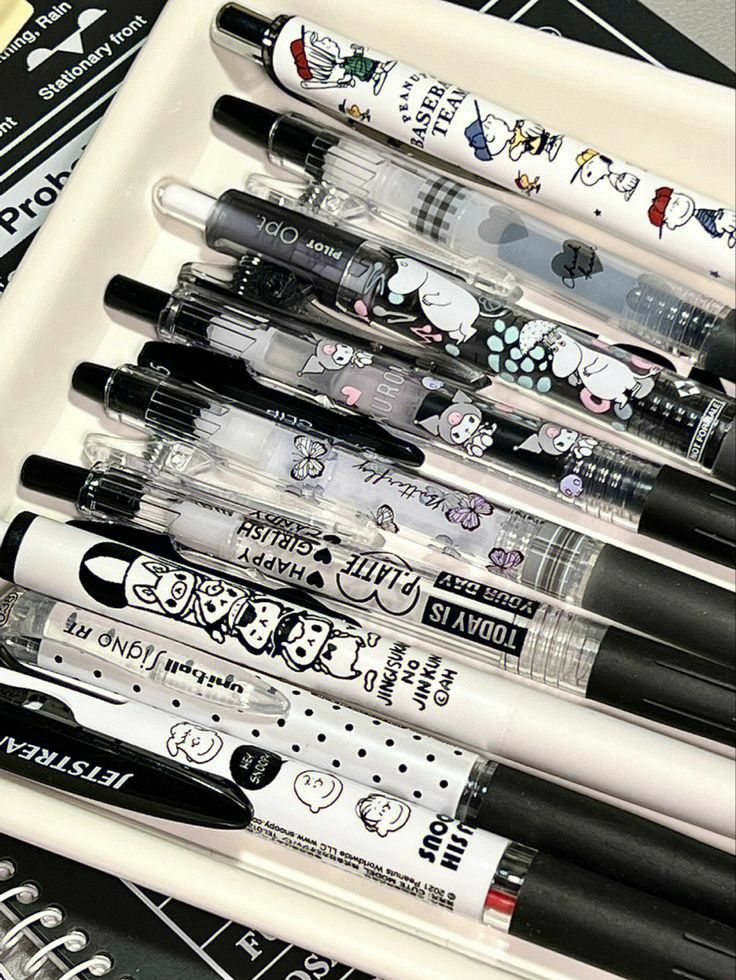 a white tray filled with lots of different types of pens and inks on top of each other