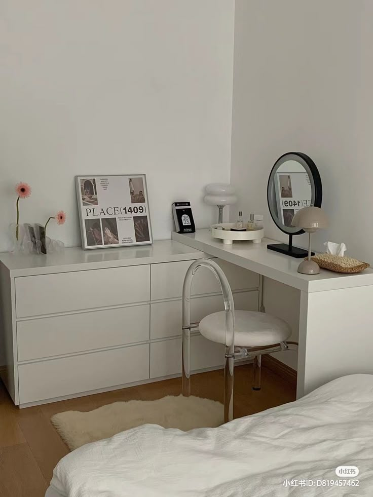 a bedroom with a white desk, mirror and chair in it's corner next to a bed