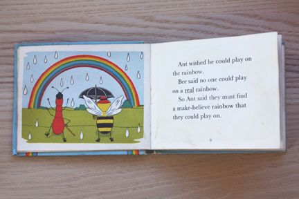 an open children's book on a wooden table with the title and page in english