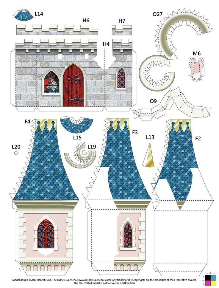 paper model of a castle with blue roof and red door, windows, and moon