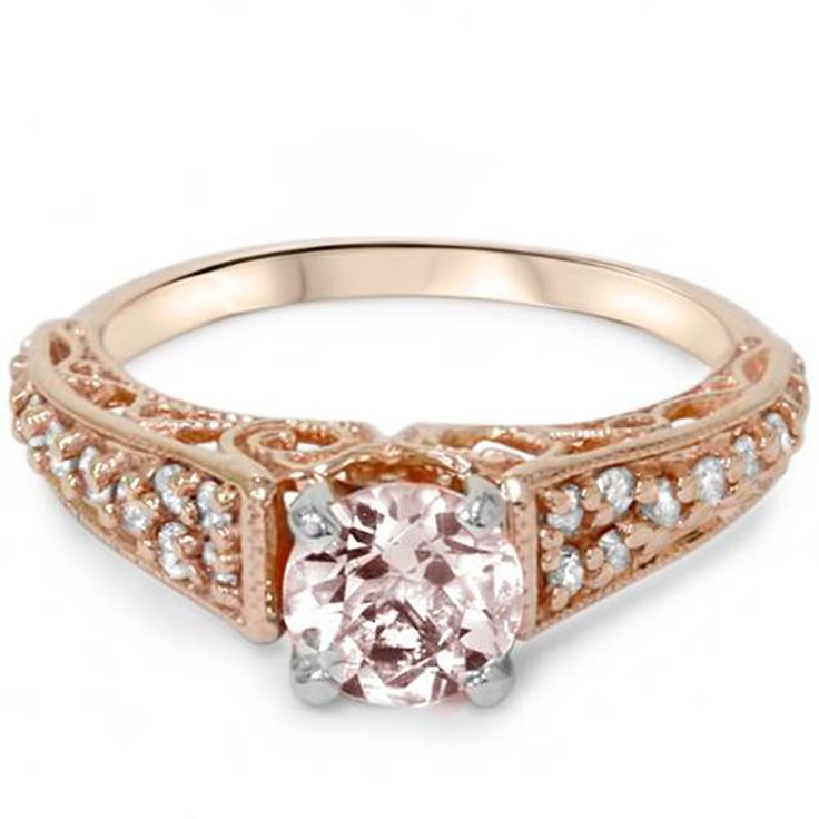 a pink diamond engagement ring set in rose gold with diamonds on the band and sides