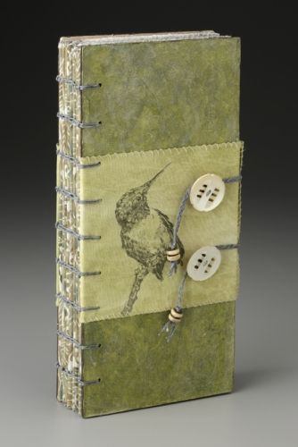 a small book with buttons on the cover