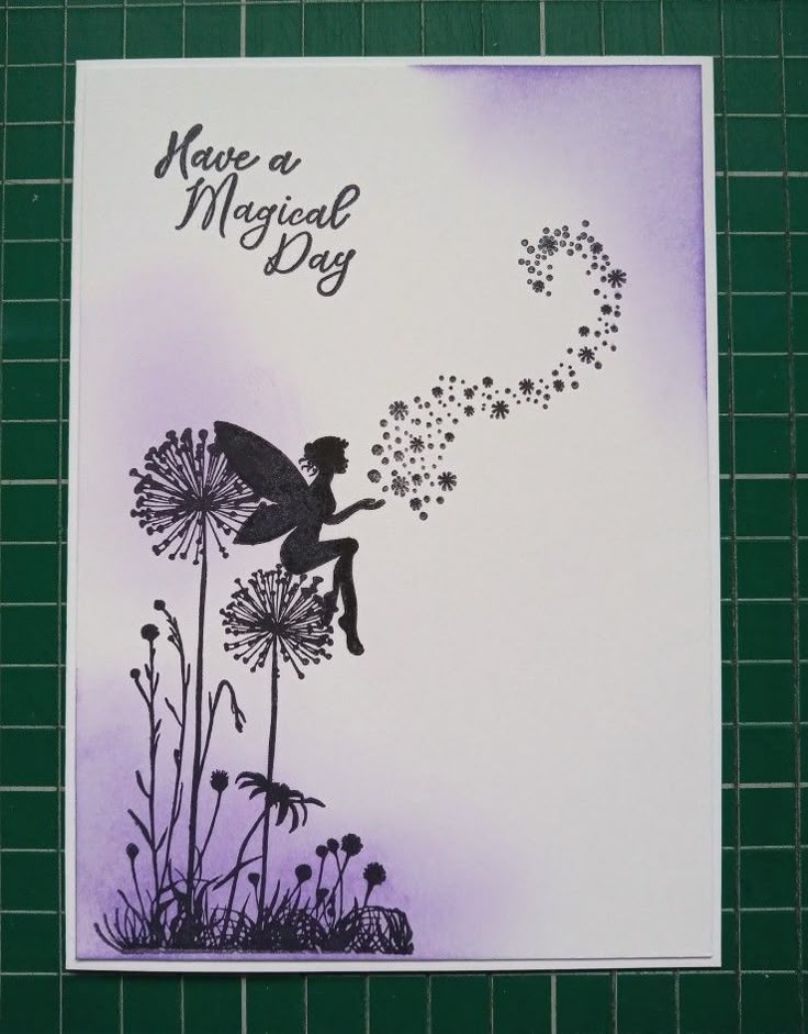 a card with a fairy sitting on top of a dandelion and blowing seeds