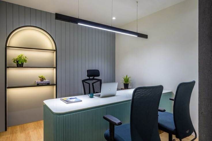 an office with chairs, desk and shelves