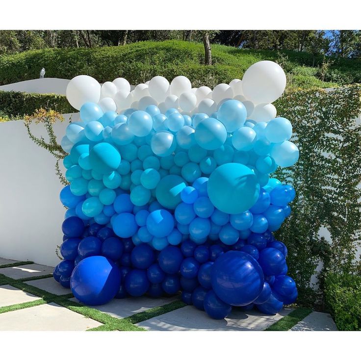 blue and white balloons are stacked on top of each other