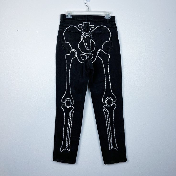 "Looking for a unique and edgy addition to your wardrobe? Look no further than these rhinestone skeleton jeans! Featuring a stunning design that combines the boldness of a skeleton with the sparkle of rhinestones, these jeans are sure to turn heads and make a statement. Crafted with high-quality denim and embellished with shimmering rhinestones, these jeans are both durable and stylish. The skeleton design adds a touch of rock 'n' roll to any outfit, whether you're dressing up for a concert or s Punk Style Costume Bottoms For Halloween, Punk Style Halloween Costume Bottoms, Punk Halloween Costume Bottoms, Fitted Bottoms For Halloween Streetwear, Halloween Skull Print Bottoms For Alternative Fashion, Grunge Halloween Bottoms With Skull Print, Halloween Grunge Bottoms With Skull Print, Halloween Jeans, Skeleton Jeans