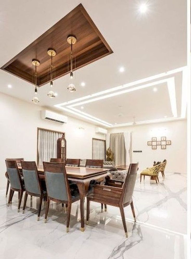 a dining room with marble flooring and white walls, along with modern lighting fixtures