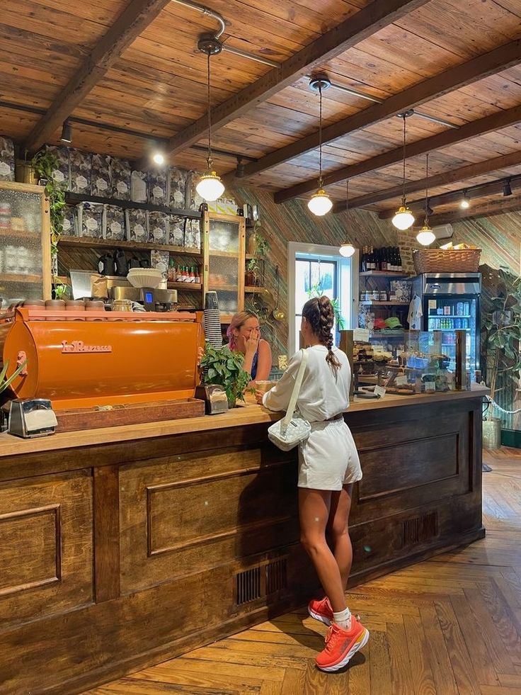 a woman standing in front of a counter at a restaurant