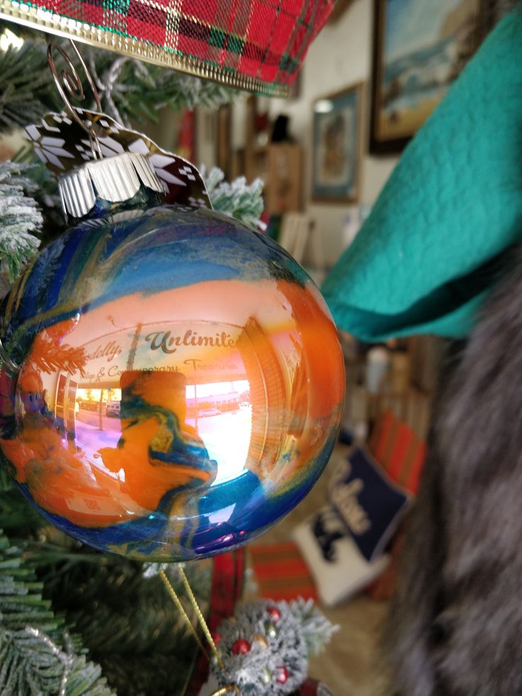 an ornament hanging from the top of a christmas tree