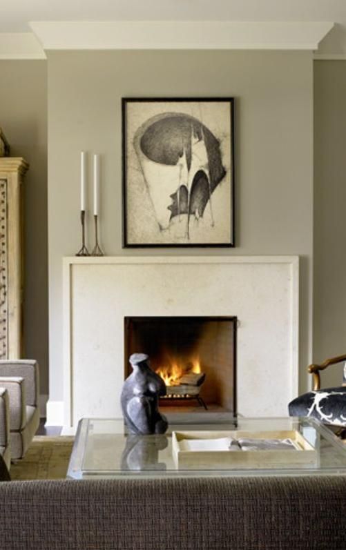 a living room filled with furniture and a fire place in the middle of a room